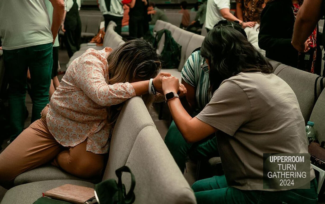 People praying at the TURN conference